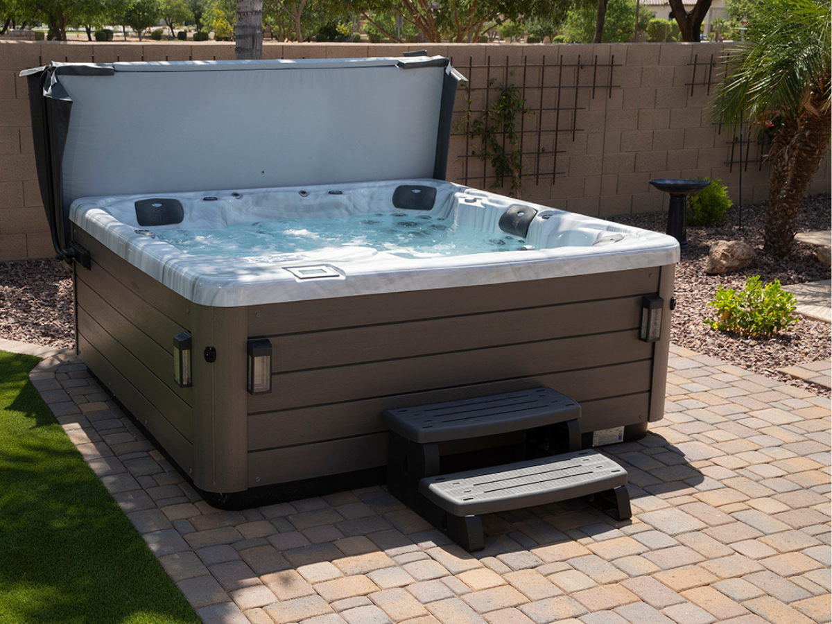 Luxury hot tub for sale in Kitchener, Waterloo, Cambridge, and Guelph with LED lighting and modern landscaping at night