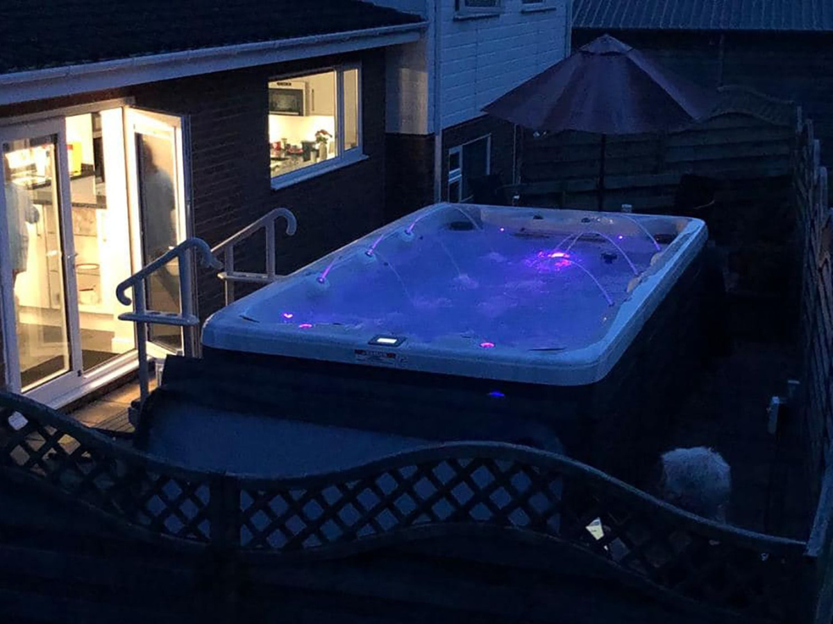 Swim spa with LED lights at night, perfect for backyard relaxation – available in Waterloo, Kitchener, Cambridge & Guelph